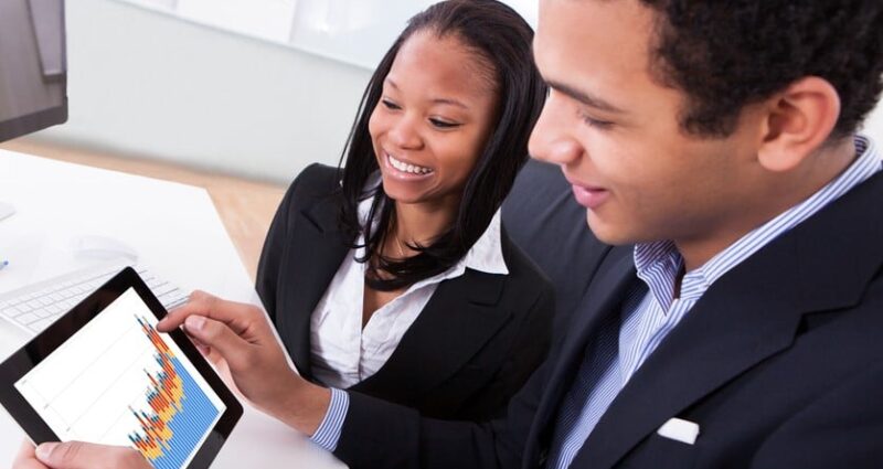 Two Businesspeople Looking At Digital Tablet