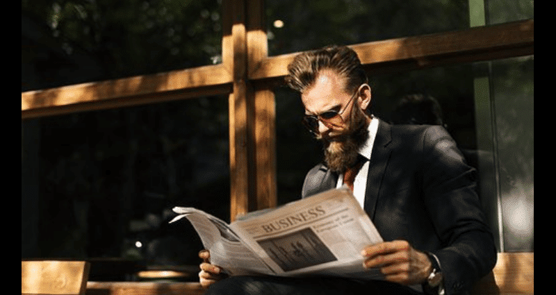 robo advisor news - man reading the newspaper