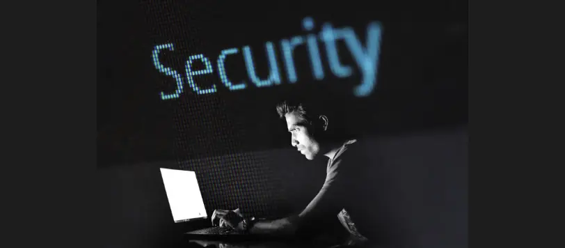 is m1 finance secure-man looking at computer in dark