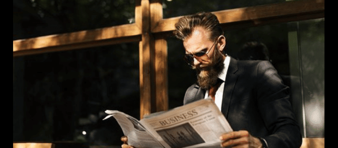 robo advisor news - man reading the newspaper
